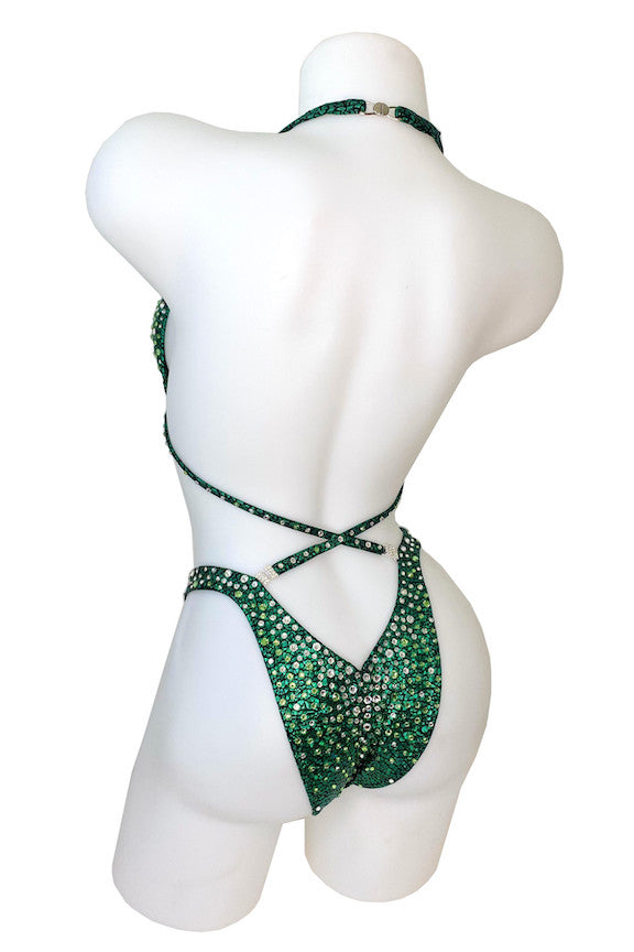 JW Couture custom Figure & Women's Physique competition suit. Crystal rhinestones fade from clear at the top, into a complimentary coloured stone. Crystal work on back matches the front. Fabric is dark green. Handmade in Canada.