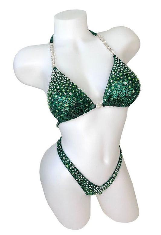 JW Couture custom Figure & Women's Physique competition suit. Crystal rhinestones fade from clear at the top, into a complimentary coloured stone. Fabric is dark green. Handmade in Canada.