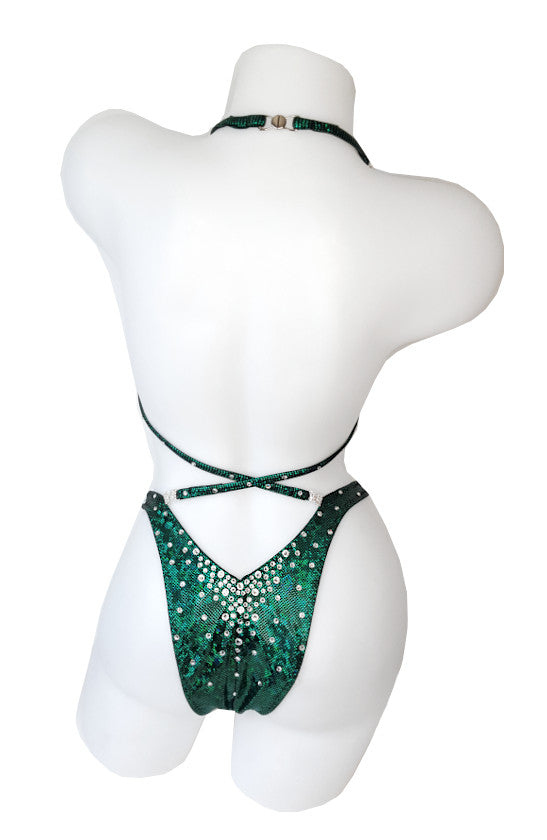JW Couture custom Figure & Women's Physique competition suit. Crystal rhinestones fade downwards on the bottoms. Crystal clips attach the straps in the back. Fabric is dark green. Handmade in Canada.