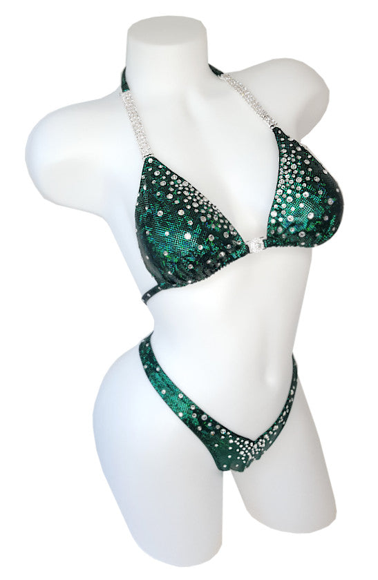JW Couture custom Figure & Women's Physique competition suit. Crystal rhinestones fade from the inside edge of the top and fade downwards on the bottoms. Fabric is dark green. Handmade in Canada.